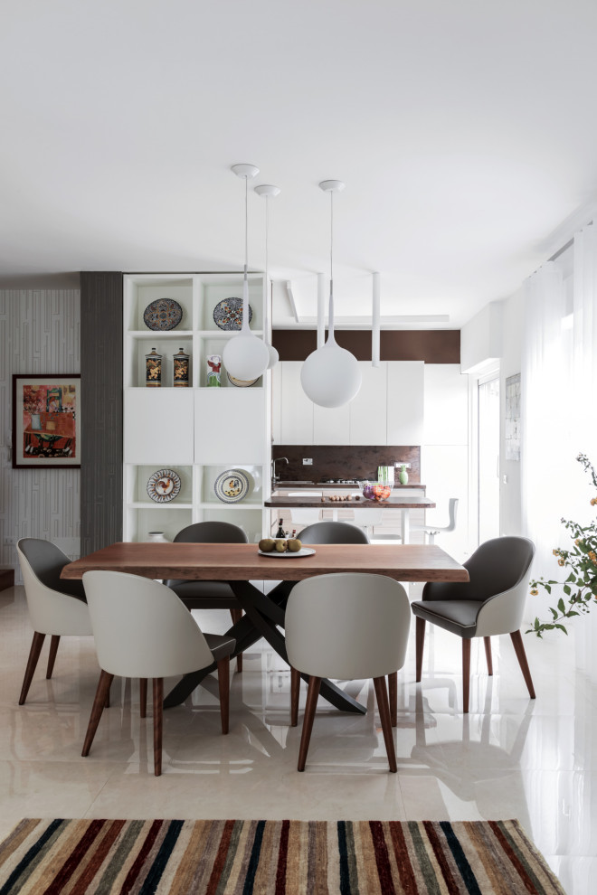 Inspiration for a contemporary open plan dining room in Milan with beige floors.