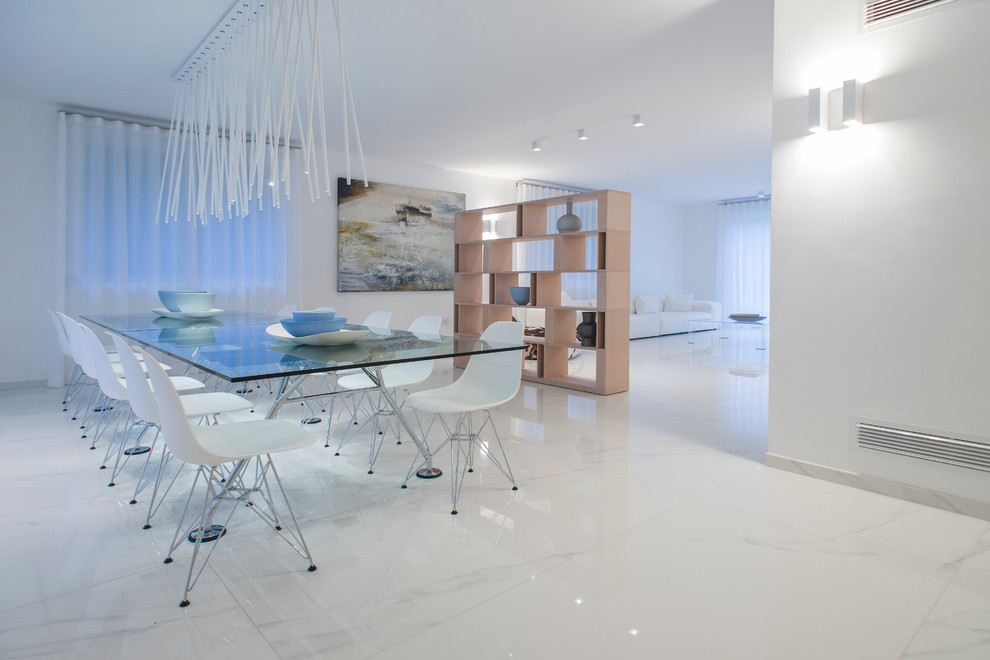 Cette photo montre une grande salle à manger ouverte sur le salon tendance avec un mur blanc et un sol en marbre.