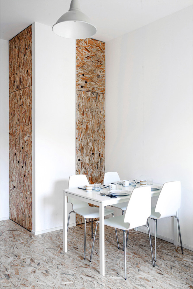 This is an example of a small contemporary dining room in Milan with white walls.