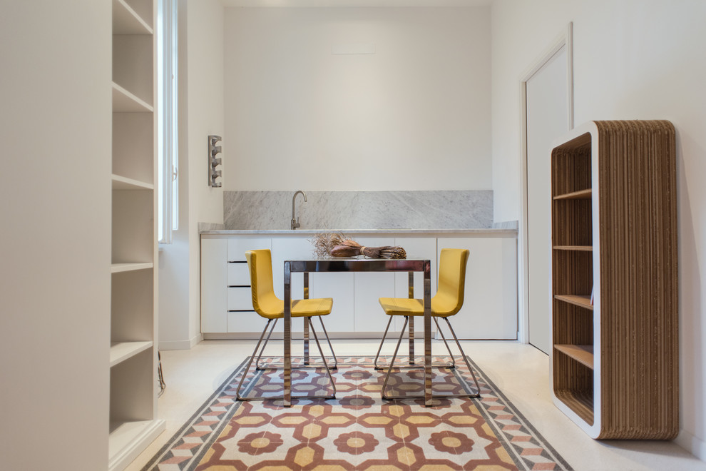 Ispirazione per una piccola sala da pranzo aperta verso la cucina contemporanea con pareti bianche, pavimento multicolore, nessun camino e pavimento in cemento