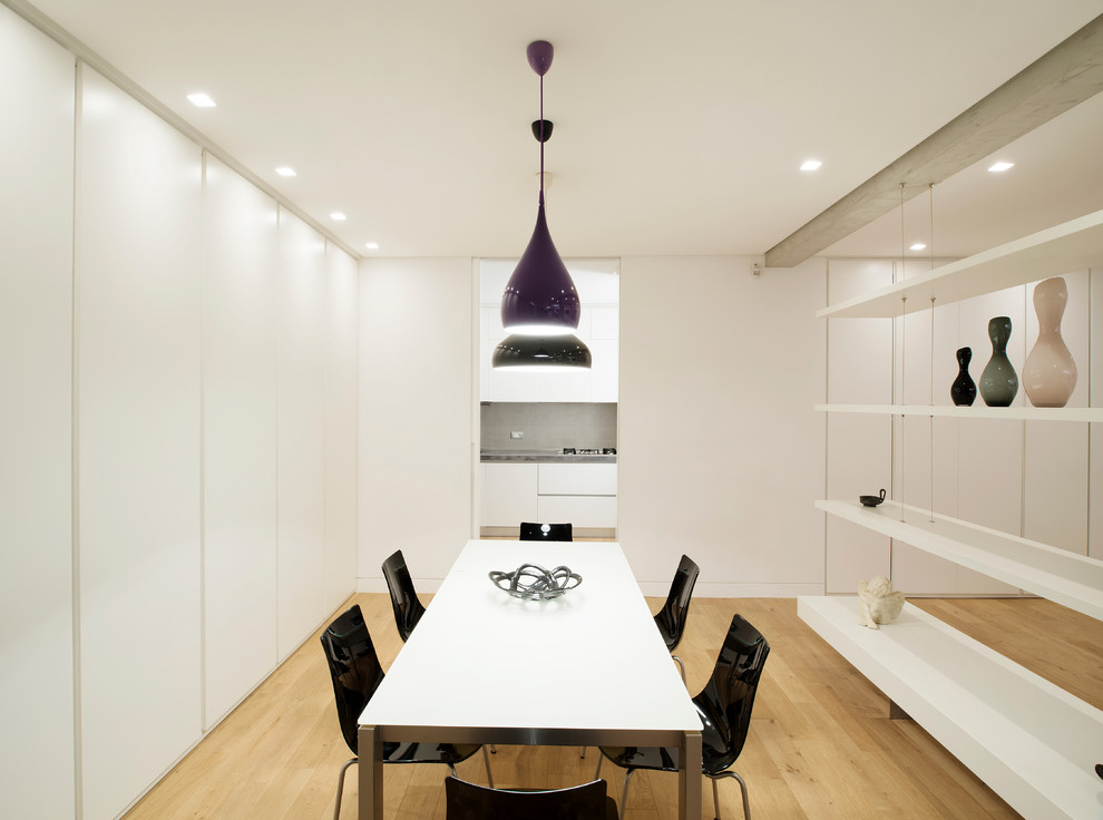 Ispirazione per una sala da pranzo aperta verso il soggiorno contemporanea con pareti bianche e pavimento in legno massello medio