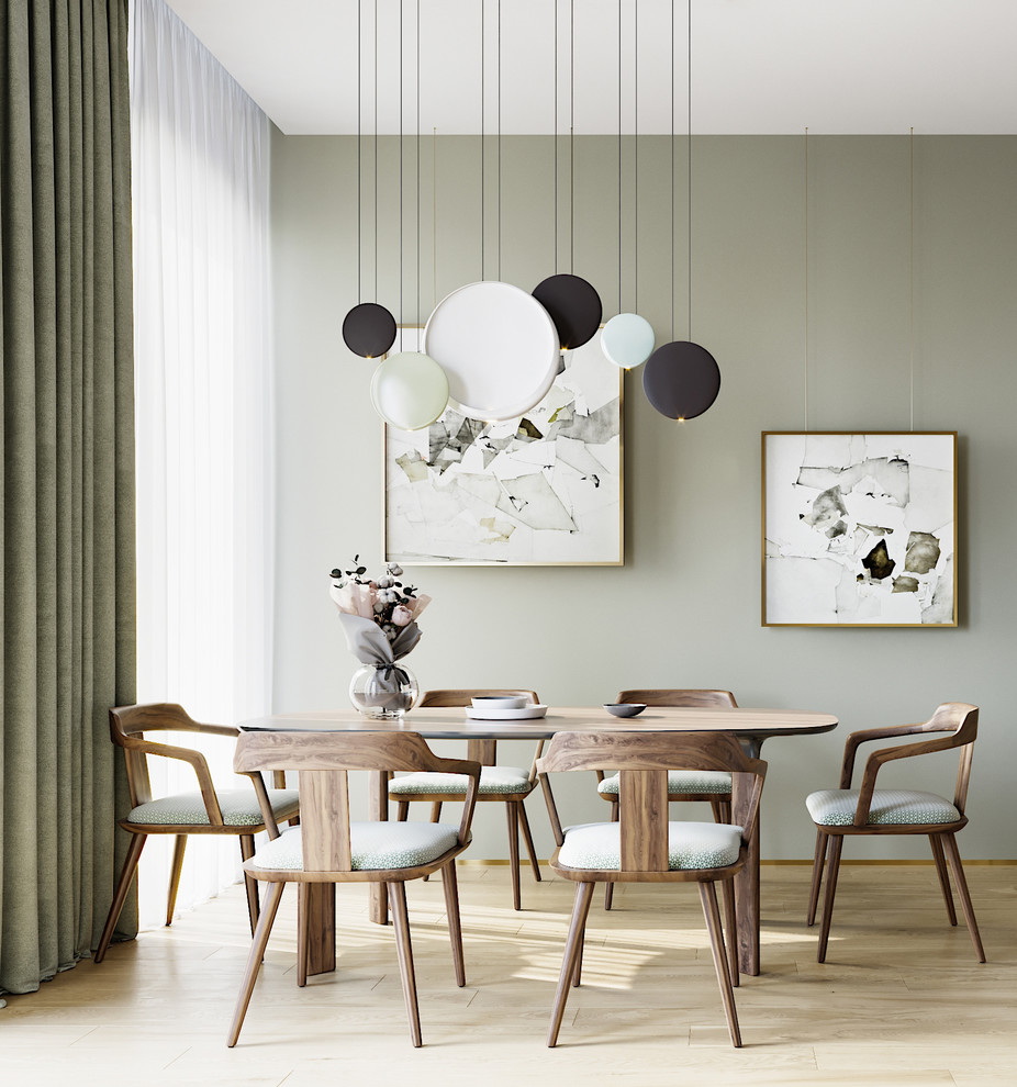 Idee per una sala da pranzo aperta verso la cucina minimalista di medie dimensioni con pareti verdi e parquet chiaro