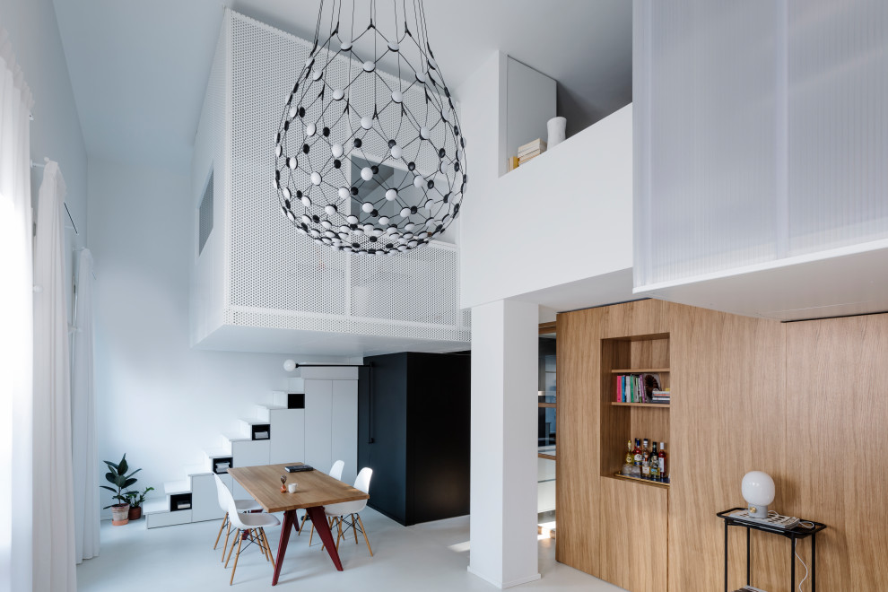 Photo of a small contemporary open plan dining room in Milan with white floors and white walls.