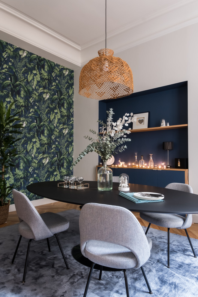 Contemporary dining room in Paris with white walls, light hardwood flooring, beige floors and wallpapered walls.