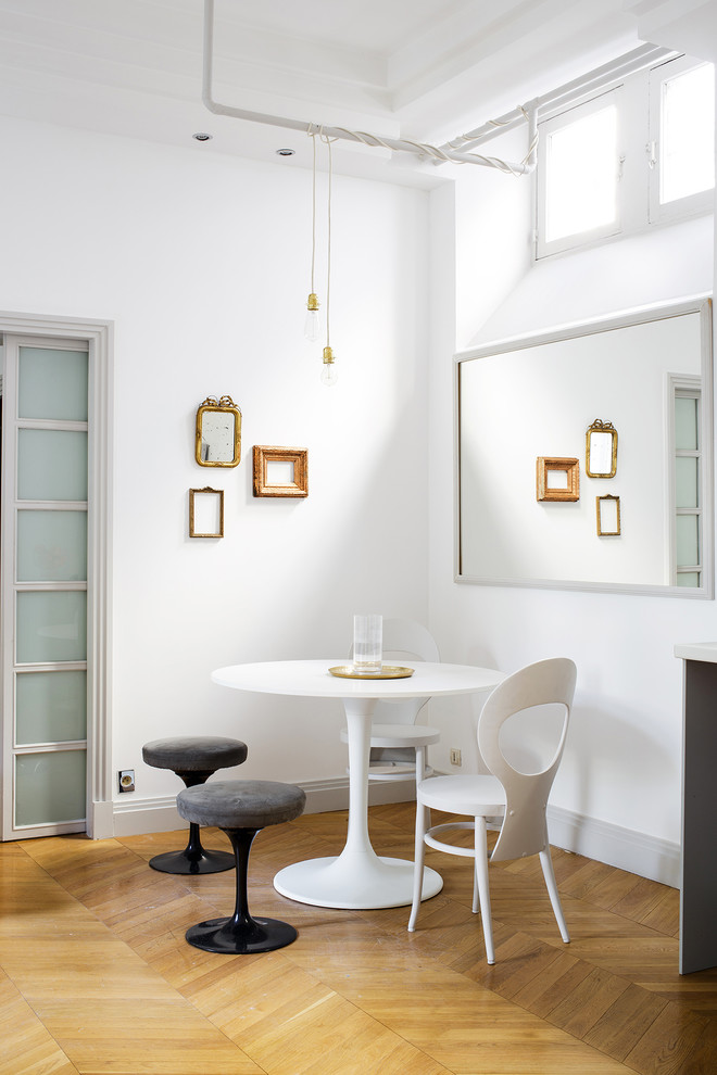 Idées déco pour une salle à manger contemporaine fermée et de taille moyenne avec un mur blanc et un sol en bois brun.