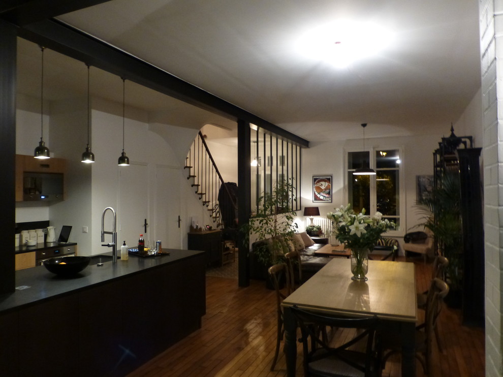 Exemple d'une grande salle à manger ouverte sur le salon tendance avec un mur blanc, un sol en bois brun et un sol marron.