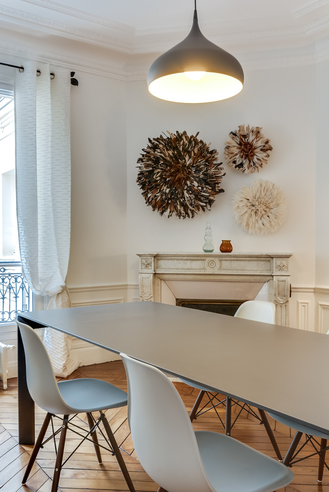 Design ideas for a contemporary dining room in Paris with white walls.