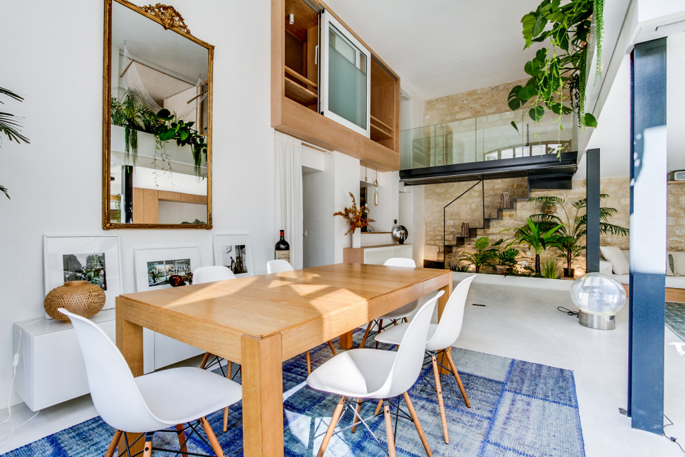 Idées déco pour une salle à manger contemporaine avec un mur blanc et un sol gris.