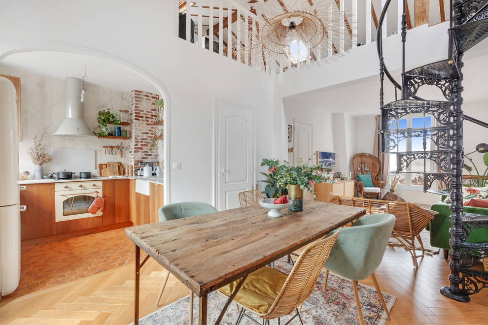 Design ideas for a medium sized scandi open plan dining room in Paris with light hardwood flooring, white walls and no fireplace.
