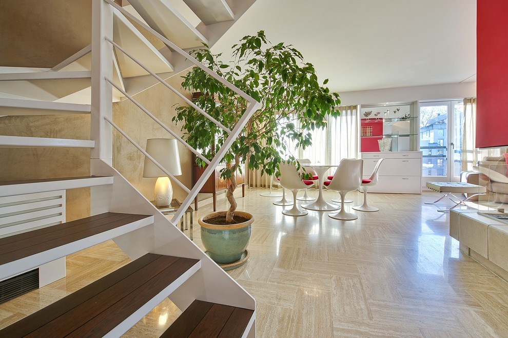 Esempio di una sala da pranzo aperta verso il soggiorno minimalista di medie dimensioni con pareti bianche