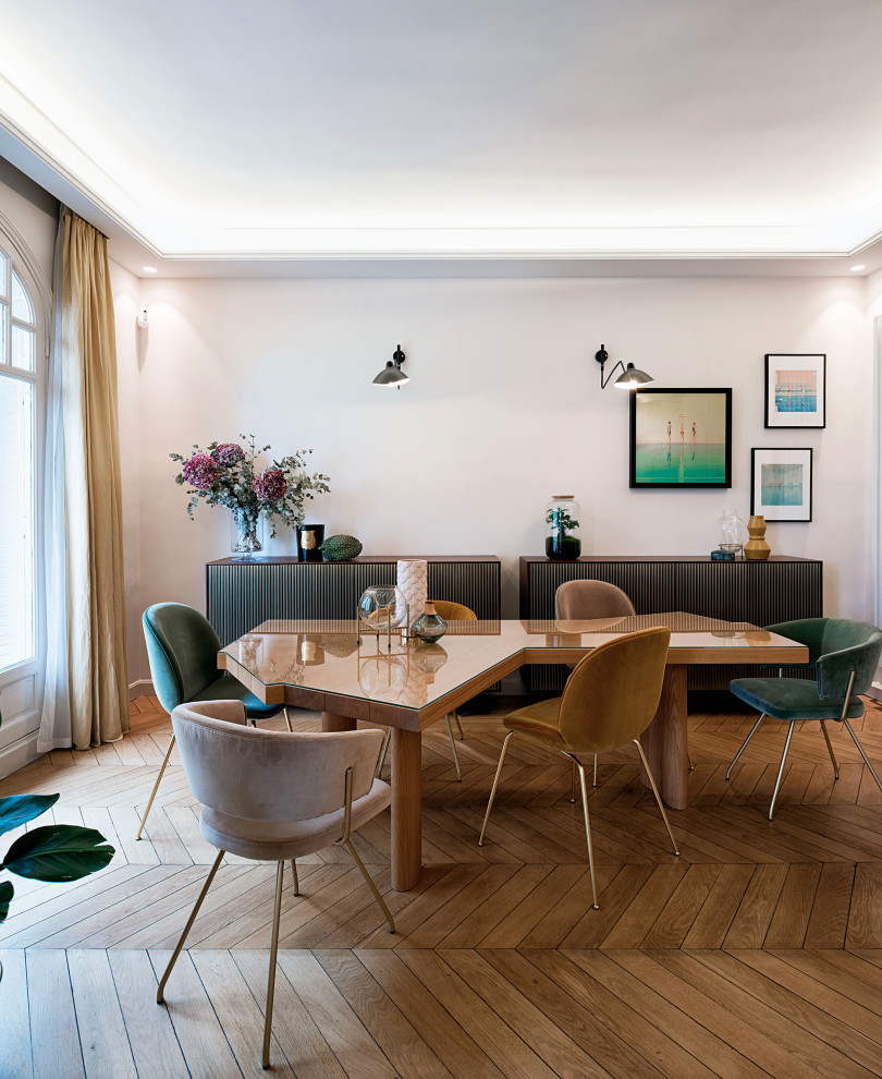 Example of a trendy medium tone wood floor, brown floor and tray ceiling dining room design in Paris with white walls