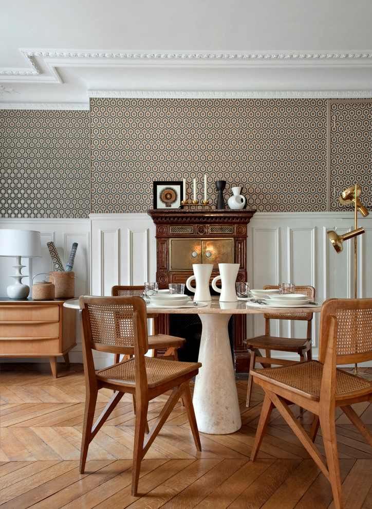 Mid-sized transitional medium tone wood floor dining room photo in Paris with multicolored walls