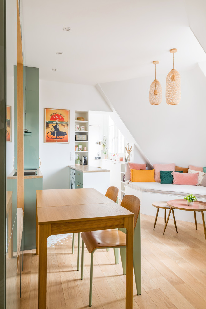 Example of a small cottage chic light wood floor and beige floor great room design in Paris with white walls and no fireplace