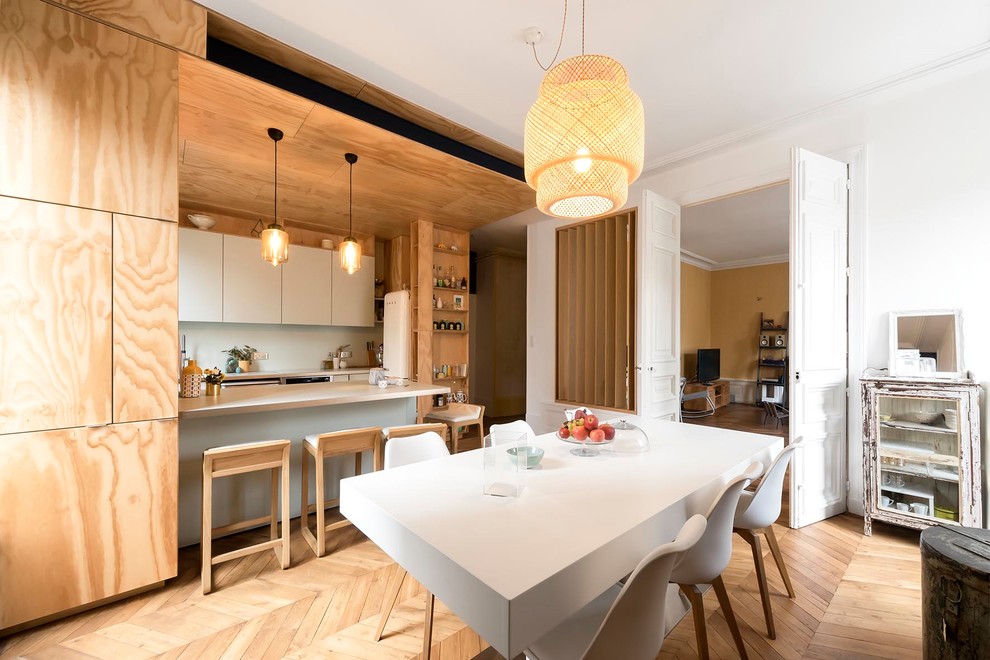 Aménagement d'une salle à manger ouverte sur la cuisine contemporaine de taille moyenne avec parquet clair, un mur blanc et un sol beige.