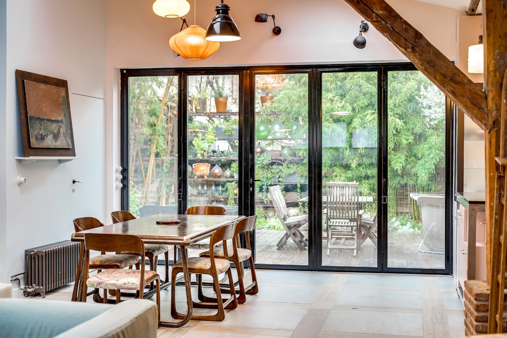 Inspiration pour une grande salle à manger ouverte sur le salon urbaine avec un mur bleu, un sol en carrelage de céramique, une cheminée standard, un manteau de cheminée en carrelage et un sol gris.