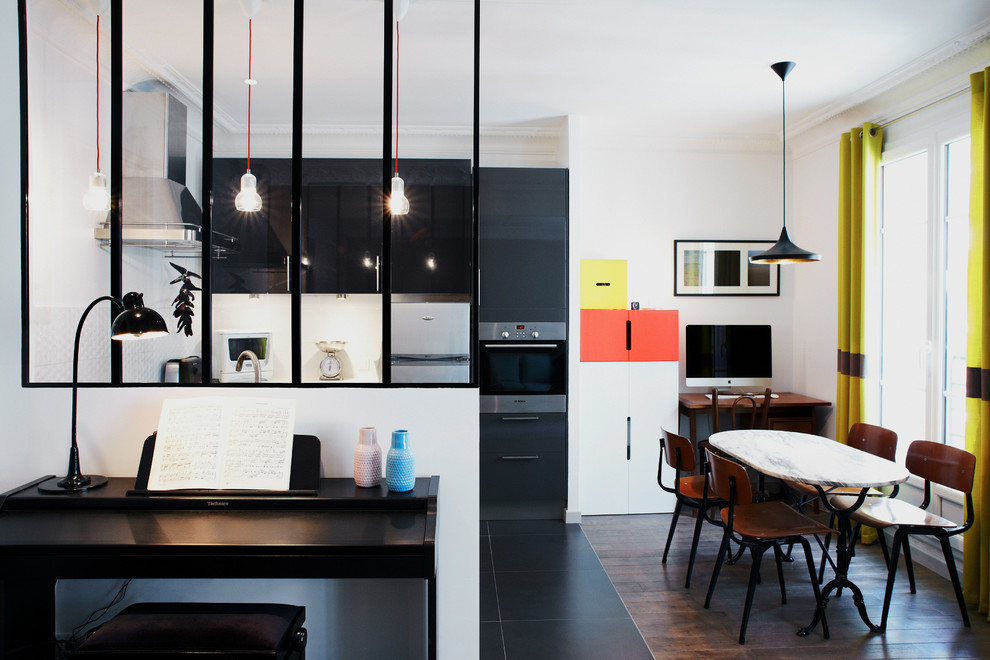 Mid-sized danish dark wood floor great room photo in Paris with white walls