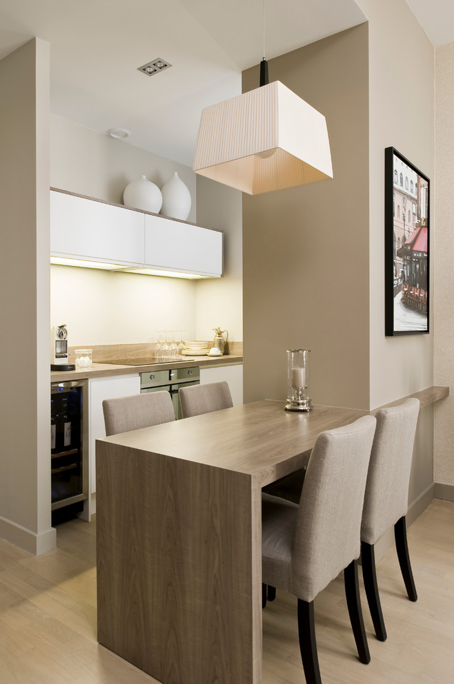 Dining room - small contemporary light wood floor dining room idea in Paris