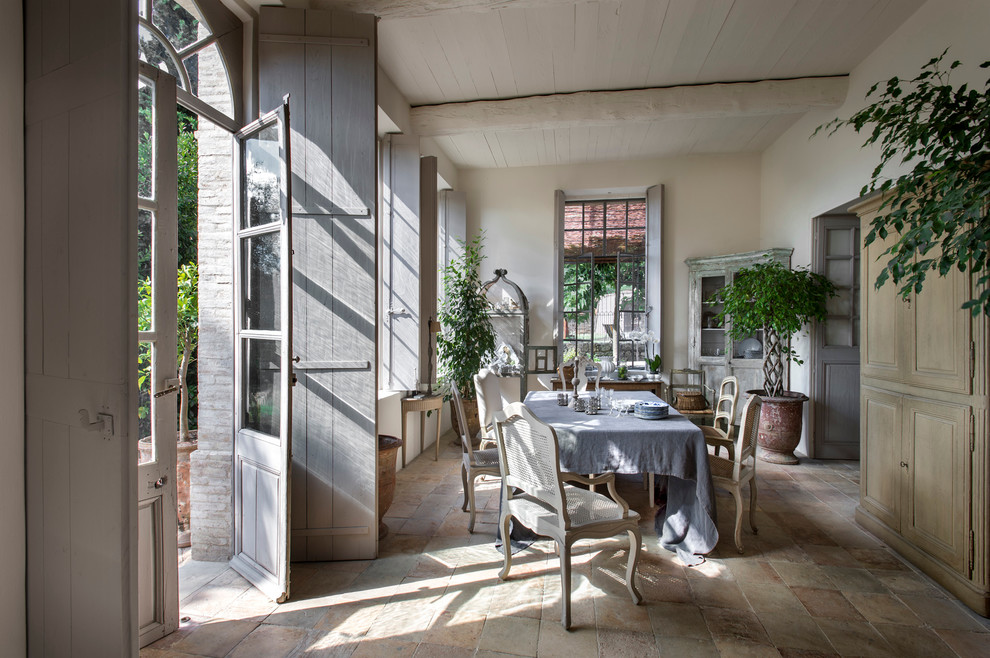 Large cottage terra-cotta tile enclosed dining room photo in Nice with white walls and no fireplace