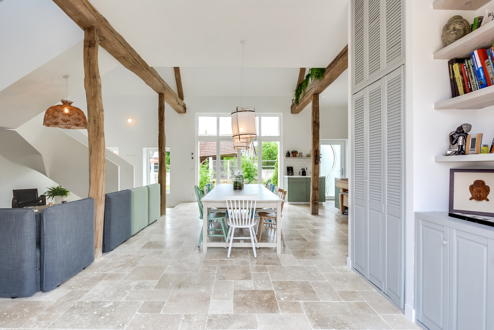 This is an example of an expansive scandinavian open plan dining room in Other with white walls, marble flooring and beige floors.