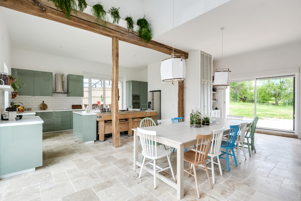 Immagine di un'ampia sala da pranzo aperta verso il soggiorno country con pareti bianche, pavimento in marmo e pavimento beige