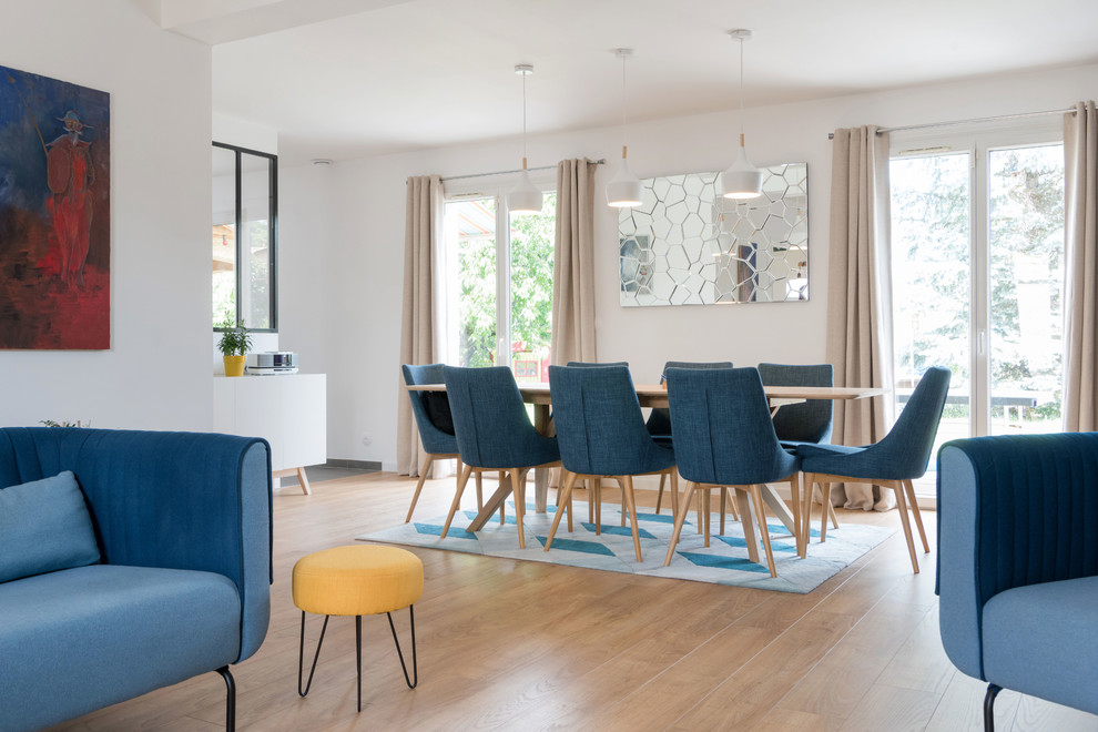 Example of a large danish light wood floor dining room design in Lyon with blue walls and no fireplace