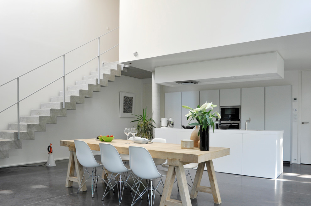 Large contemporary kitchen/dining room in Lille with white walls and no fireplace.