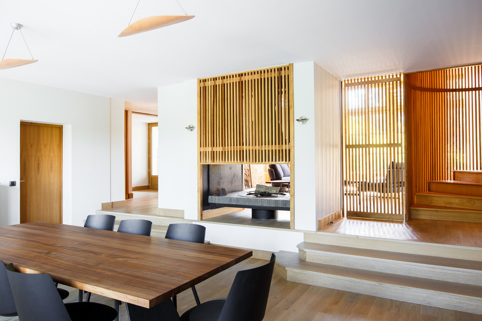 Стильный дизайн: гостиная-столовая среднего размера в современном стиле с белыми стенами и светлым паркетным полом - последний тренд