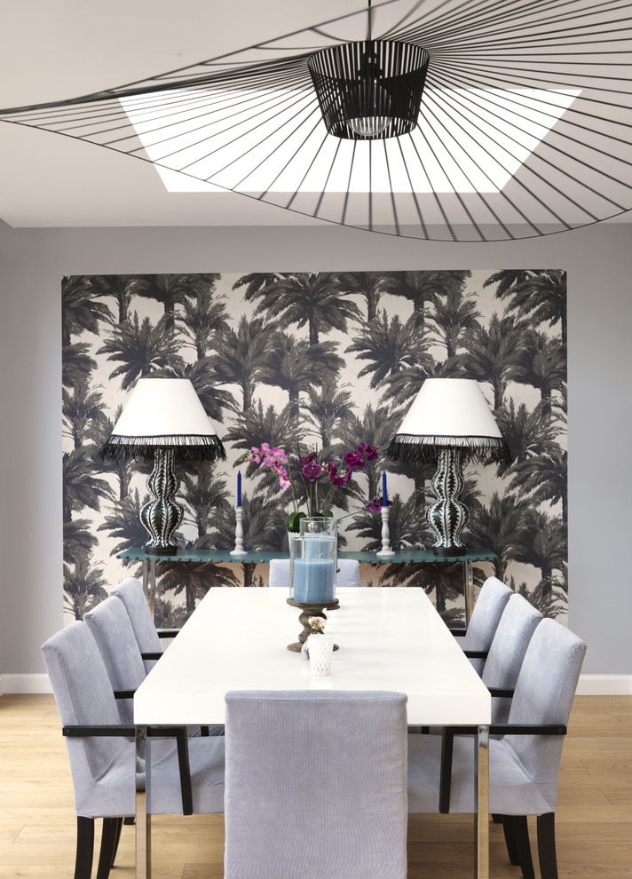 Large contemporary enclosed dining room in Marseille with grey walls, light hardwood flooring and feature lighting.