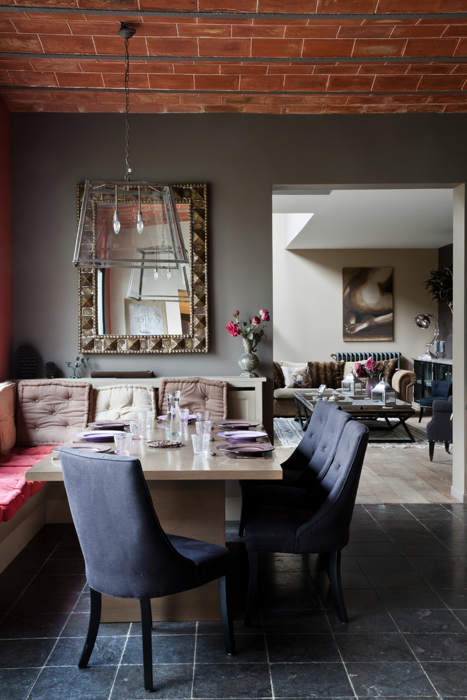 This is an example of a medium sized eclectic enclosed dining room in Paris with grey walls and no fireplace.