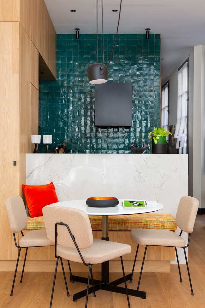 Idée de décoration pour une petite salle à manger ouverte sur le salon design avec parquet clair, un mur bleu et aucune cheminée.