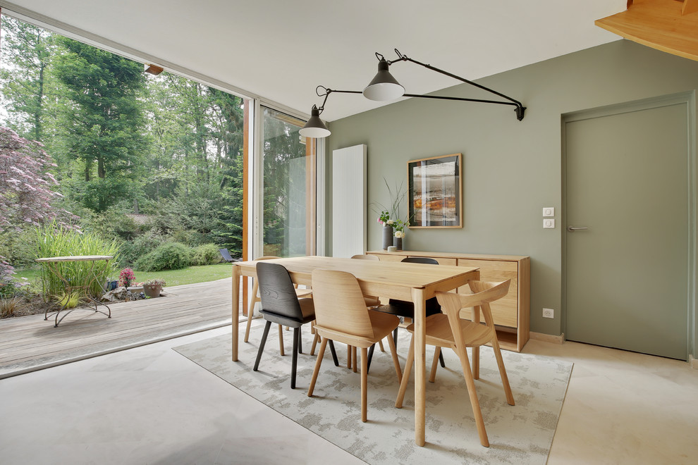 Large mid-century modern beige floor dining room photo in Paris with green walls
