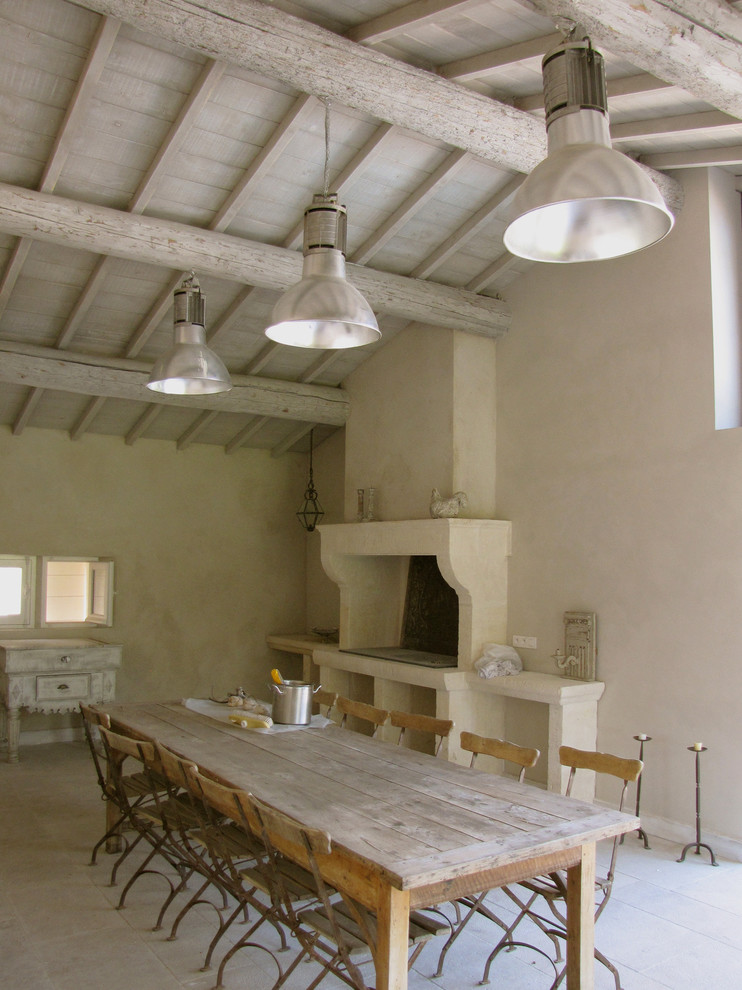 Große Landhausstil Wohnküche mit beiger Wandfarbe, Kamin und Kaminumrandung aus Stein in Marseille