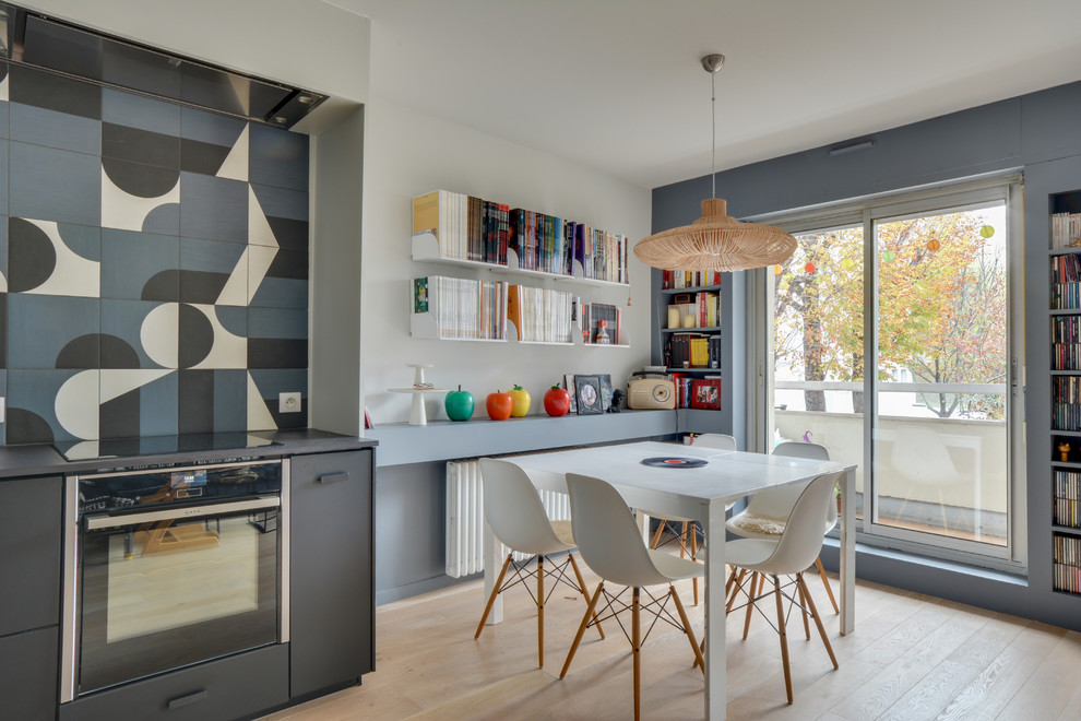 На фото: кухня-столовая в скандинавском стиле с серыми стенами, светлым паркетным полом и бежевым полом