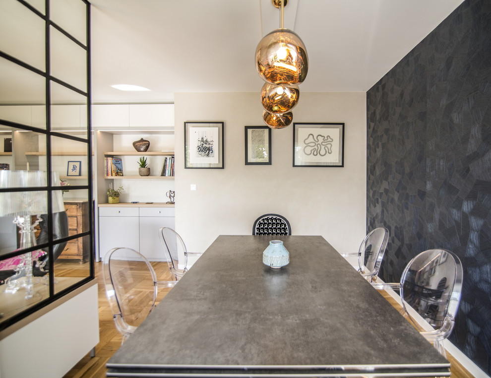 This is an example of a medium sized bohemian open plan dining room in Strasbourg with beige walls, light hardwood flooring and brown floors.