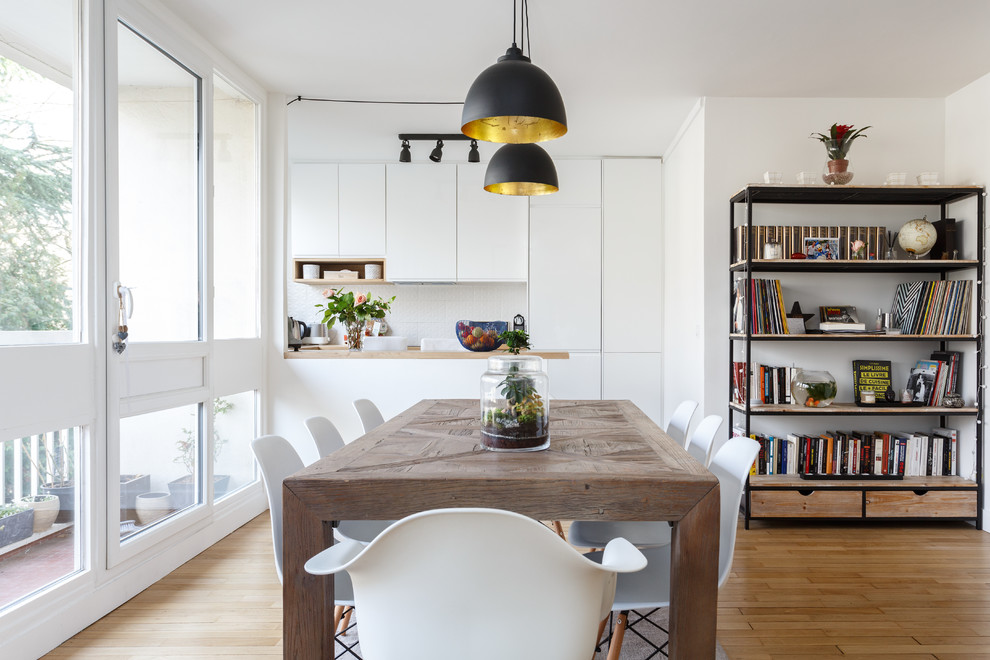 Ispirazione per una sala da pranzo aperta verso il soggiorno minimalista di medie dimensioni con pareti bianche, parquet chiaro, pavimento beige e nessun camino