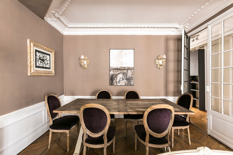 Medium sized classic enclosed dining room in Paris with beige walls, medium hardwood flooring and no fireplace.