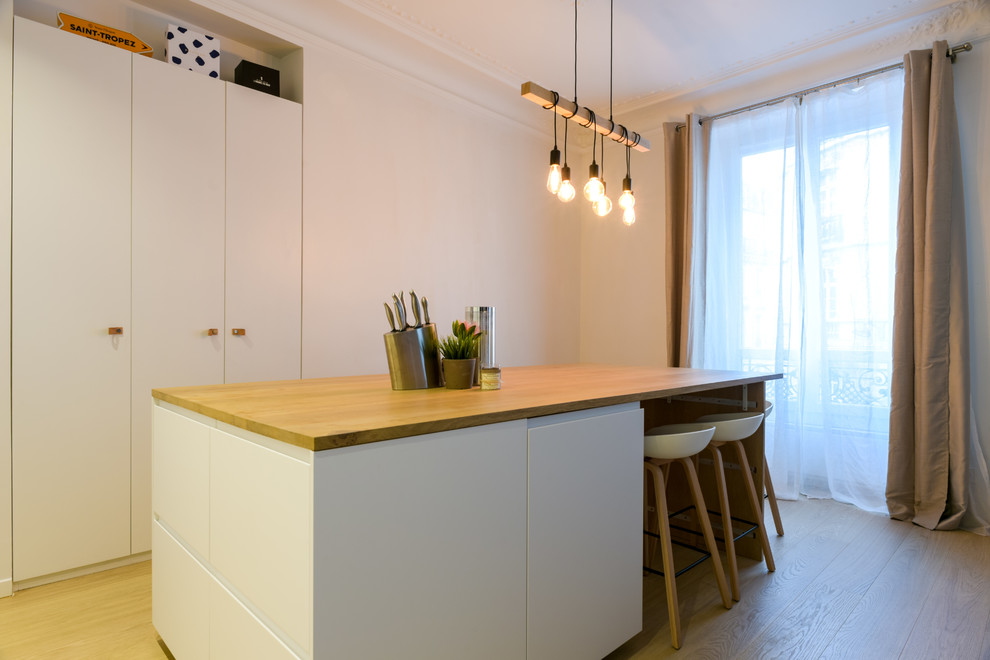Exemple d'une petite salle à manger ouverte sur le salon tendance avec un mur blanc, parquet clair, aucune cheminée et un sol beige.