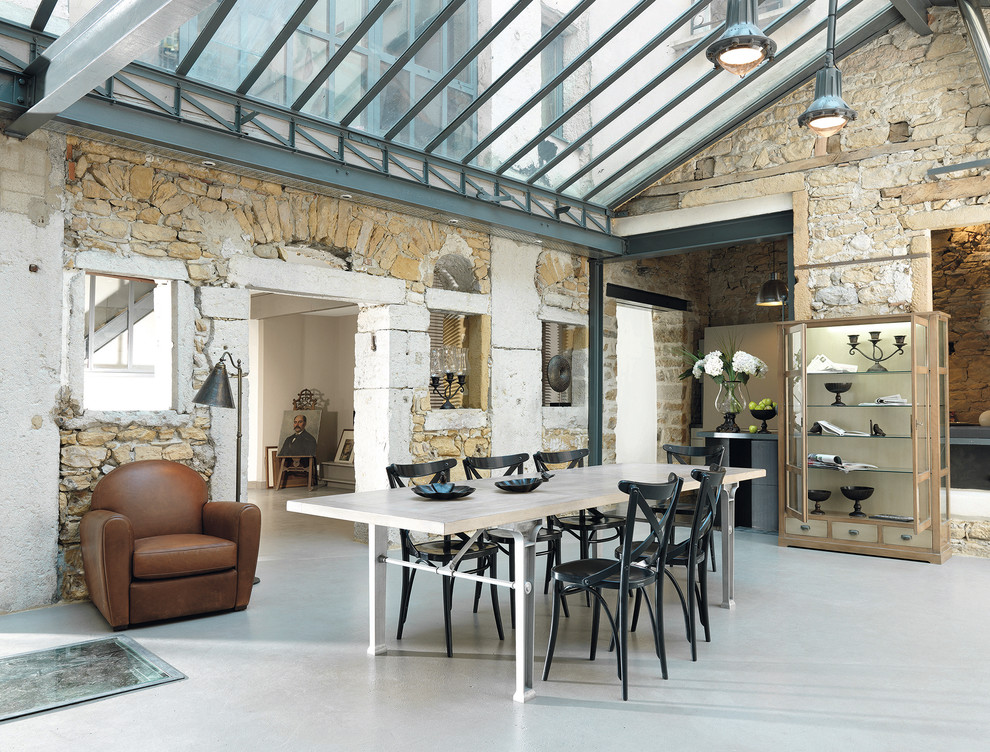 This is an example of a large industrial open plan dining room in Paris with beige walls.