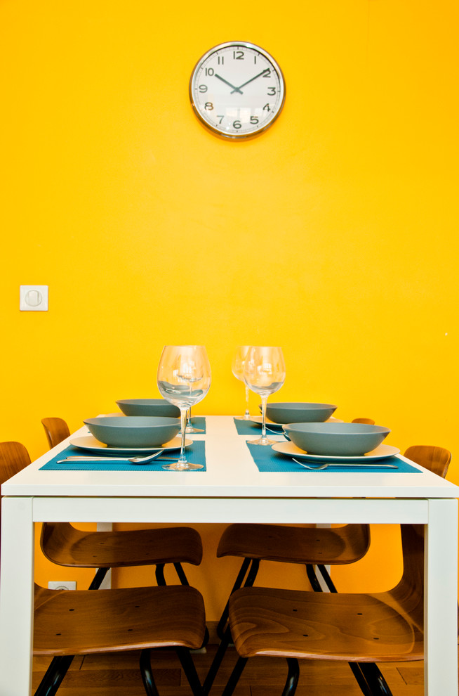 Offenes, Mittelgroßes Modernes Esszimmer mit gelber Wandfarbe und braunem Holzboden in Lyon