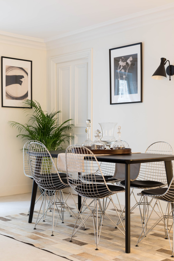 This is an example of a medium sized contemporary dining room in Paris with white walls and white floors.