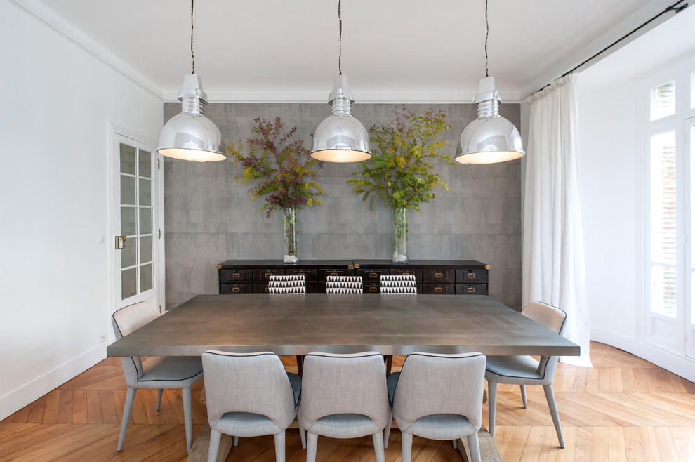 Inspiration for a transitional light wood floor and beige floor enclosed dining room remodel in Paris with gray walls