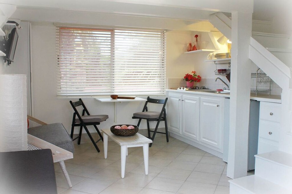 Photo of a small scandi dining room in Other with white walls and ceramic flooring.