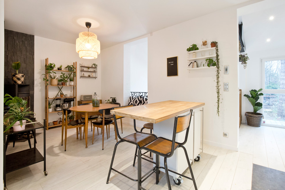 Great room - small scandinavian light wood floor great room idea in Paris with white walls and no fireplace
