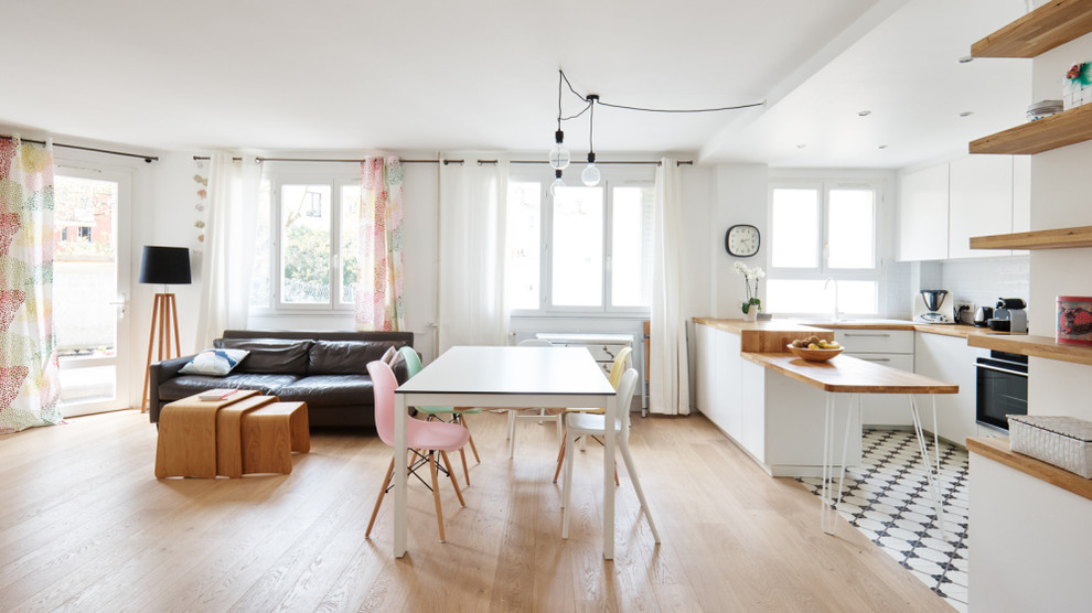 Mid-sized trendy light wood floor great room photo in Paris with white walls