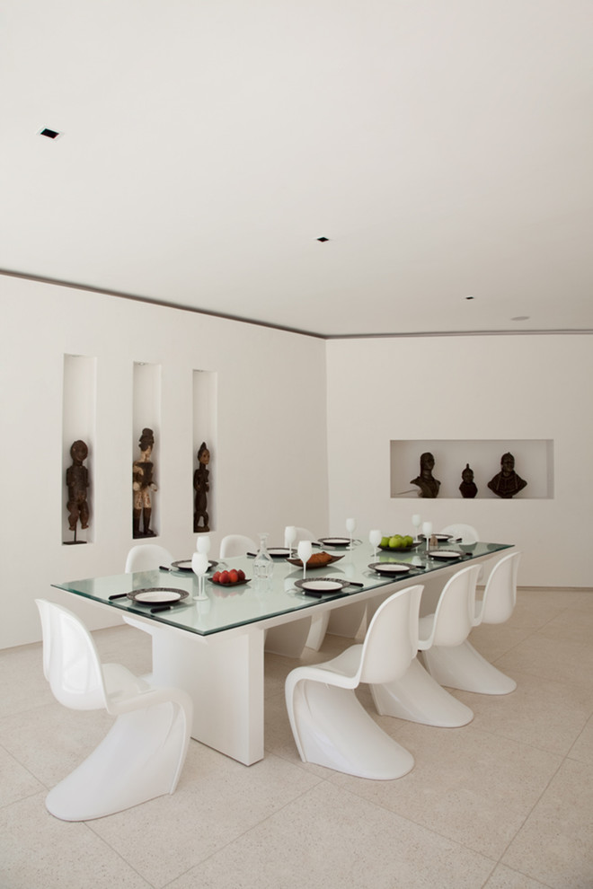 Photo of an expansive contemporary enclosed dining room in Other with white walls and marble flooring.