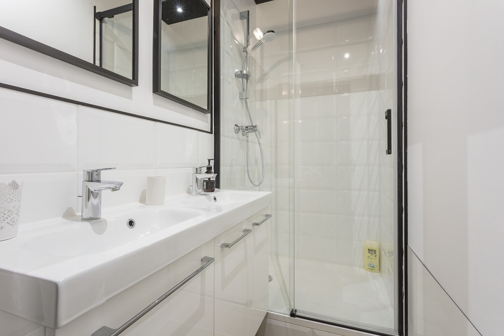 Exemple d'une petite salle de bain industrielle avec un carrelage blanc, des carreaux de céramique, un mur blanc, parquet foncé, un plan vasque, un sol beige et une cabine de douche à porte battante.