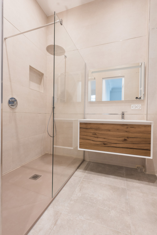 Photo of a medium sized modern ensuite bathroom in Paris with beaded cabinets, dark wood cabinets, a built-in shower, beige tiles, ceramic tiles, beige walls, ceramic flooring, a submerged sink, solid surface worktops, beige floors, a single sink and a floating vanity unit.
