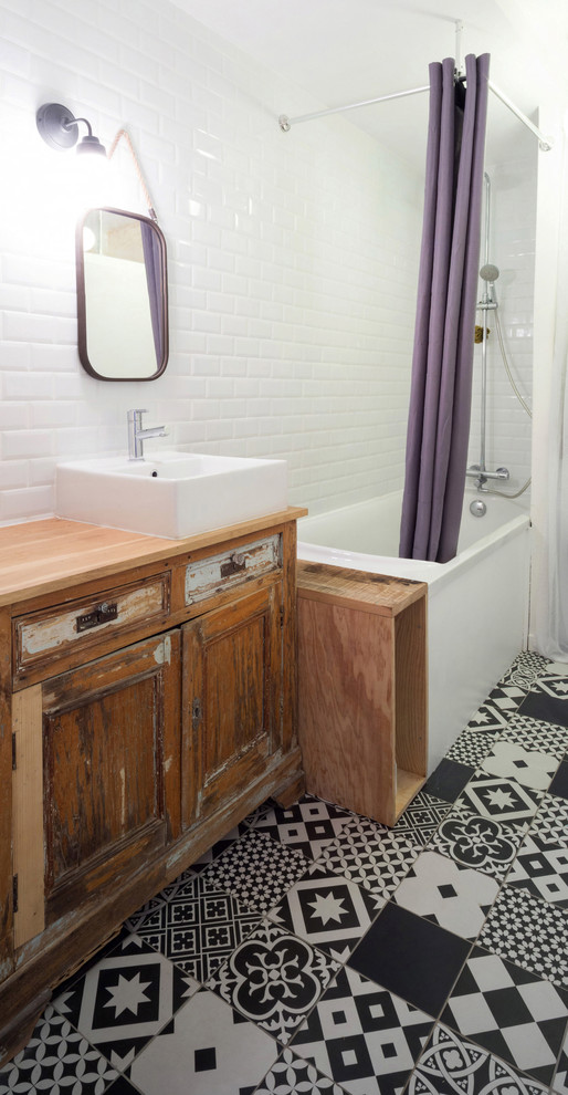 Design ideas for a medium sized bohemian ensuite bathroom in Bordeaux with distressed cabinets, a freestanding bath, black and white tiles, cement tiles, white walls, cement flooring and a built-in sink.
