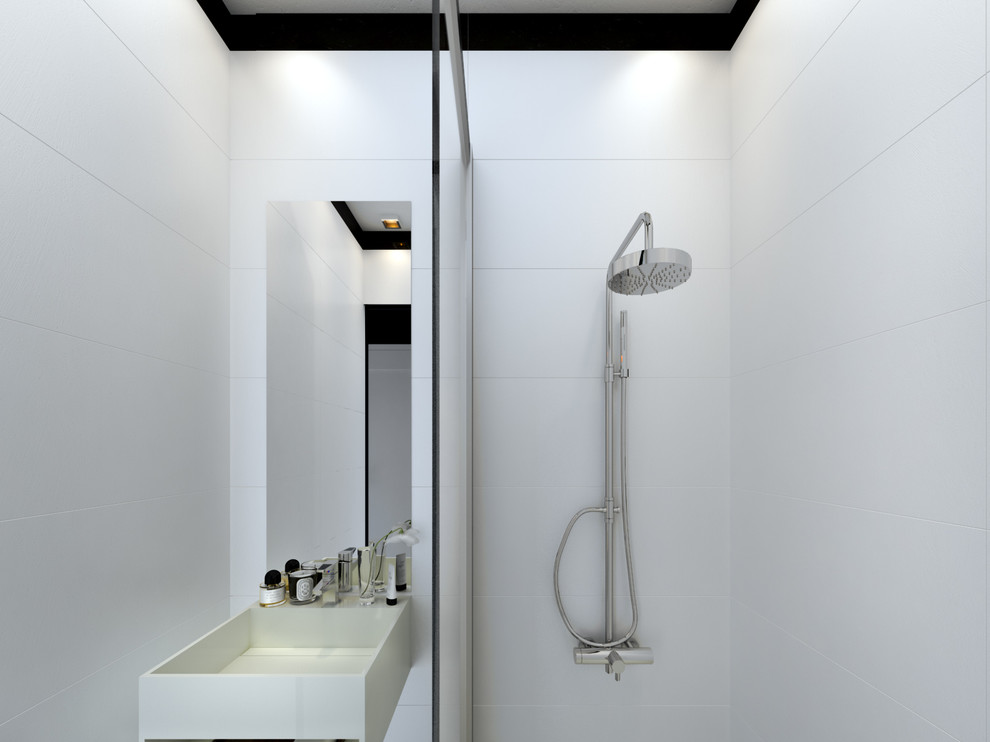 Cette photo montre une petite salle d'eau tendance avec un carrelage blanc, un mur blanc, un sol en carrelage de céramique, un plan vasque, un plan de toilette en surface solide, des portes de placard blanches, une douche à l'italienne, un sol noir et meuble-lavabo suspendu.