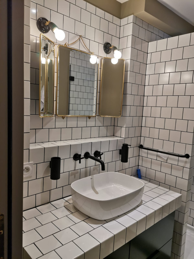 Свежая идея для дизайна: маленькая ванная комната в стиле модернизм с фасадами с декоративным кантом, черными фасадами, душем без бортиков, белой плиткой, керамической плиткой, бежевыми стенами, полом из керамической плитки, душевой кабиной, накладной раковиной, столешницей из плитки, черным полом, душем с распашными дверями, белой столешницей, тумбой под одну раковину и подвесной тумбой для на участке и в саду - отличное фото интерьера